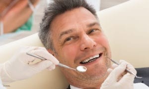 Mature Male Smiling During Dental Exam